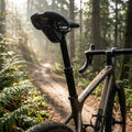 Rockshox Reverb AXS XPLR Sattelstütze 27.2mm schwarz 50mm Hub am Fahrrad auf sonnigem Waldweg.