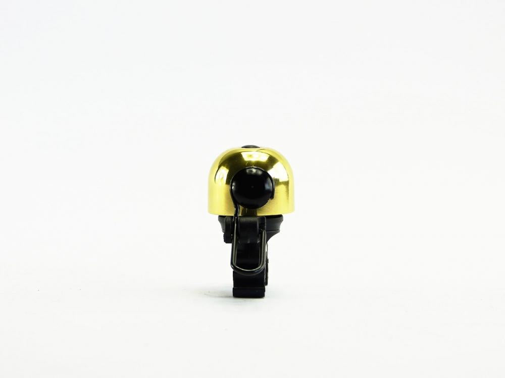 NG Sports Thian Fahrradklingel, goldene Glocke mit schwarzer Halterung, auf weißem Grund.