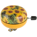 Messingschlager Fahrradklingel Ø 80mm mit farbigem Sonnenblumenmotiv auf gelbem Grund.