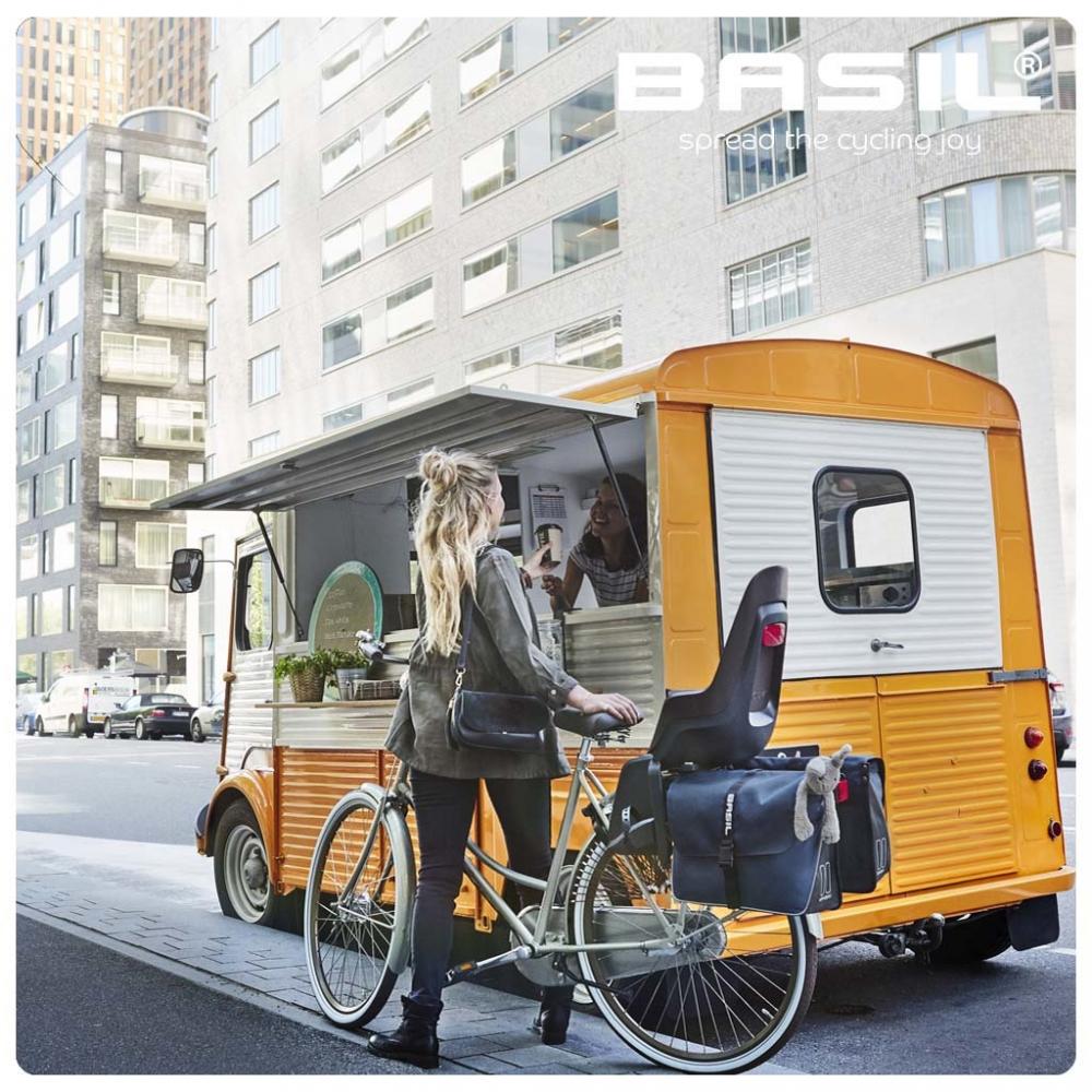 Basil Carrier Extender Gepäckträger-Verlängerung am Fahrrad mit Kindersitz und Packtaschen vor Foodtruck.