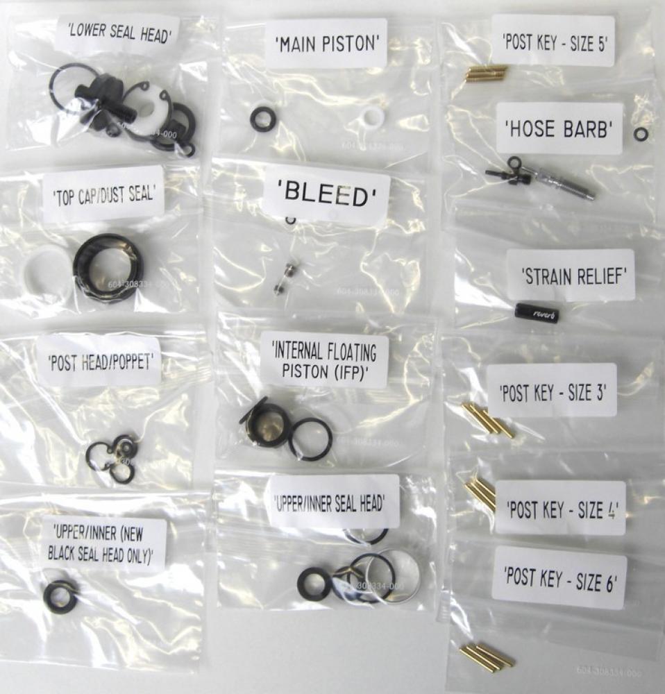 Reverb Full Service Kit 11.6818.003.010: Fahrrad-Ersatzteile wie Dichtungen, Kolben, Post Keys in beschrifteten Beuteln.