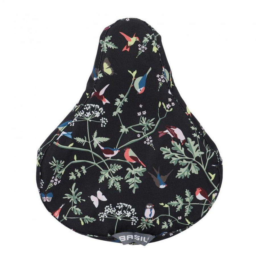 Basil Sattelüberzug Wanderlust charcoal mit buntem Vogel- und Blumenmuster für Fahrräder.
